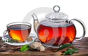 Tea ceremony. Glass teapot with brewed tea and a cup stands on an old table