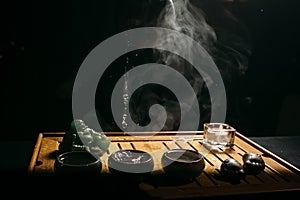 Tea ceremony. The man pours hot chinese tea into the tea cup