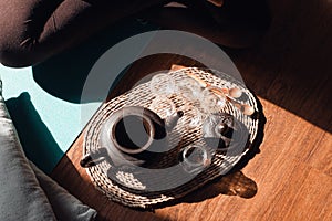 Tea ceremony set. Clay teapot, mugs, wooden spoons on a tray indoors, top view