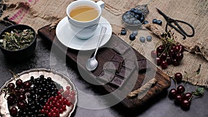Tea with chocolate and brown sugar. Close-up 4k video shooting, dark background