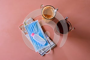 Tea and coffee in hawker centre, with travelling essentials of map, face mask, and hand sanitiser on table during coronavirus