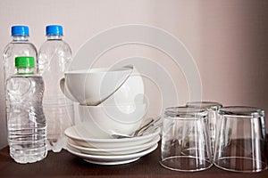 Tea and coffee making set in luxury hotel room with clean cups, glasses and bottles of water, copy space.