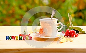 Tea, coffee in a mug on the table in the garden, colored letter words, the concept of outdoor tea drinking, good weather, a cozy