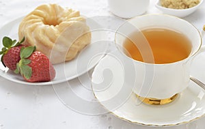 Tea with cruller and strawberries