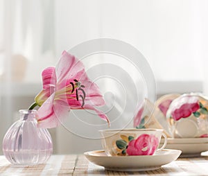 The tea cup is decorated with nicely pink flowers.