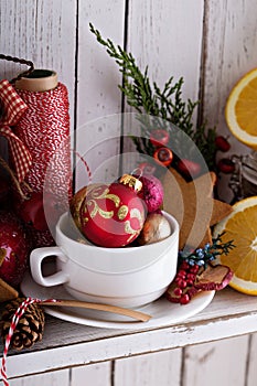 Tea cup with decorations, cookies and oranges for Christmas