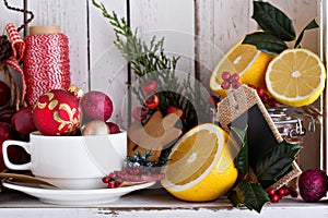 Tea cup with decorations, cookies and oranges for Christmas