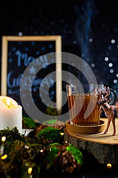 Tea cup and deer figurine in cozy Christmas still life, vertical