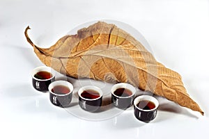 Tea cup with dried leaf