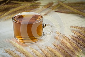 Tea cup and Flowers grass on white wooden background