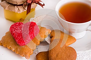 Tea cup with heart shaped biscuits. Sugar red biscuits.