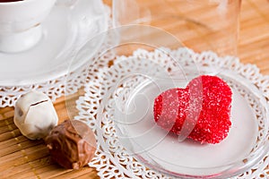Tea cup with heart shaped biscuits. Sugar red biscuits.