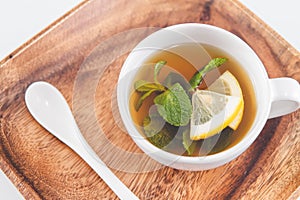 Tea cup of mint leaves with fresh slice lemon