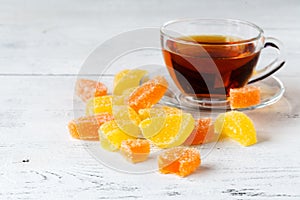 Tea cup with orange marmalade on table, breakfast concept