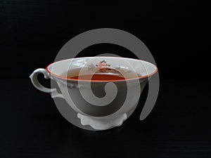 Tea cup porcelein old fashion/vintage white with black background