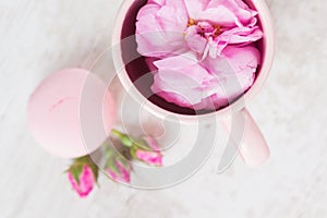 Tea cup with rose and macaroons, pastel colored