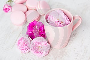 Tea cup with rose and macaroons