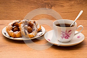 Tea Cup and saucer with donuts.