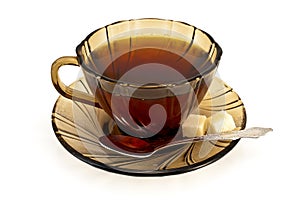 Tea in a cup with a spoon of brown sugar and