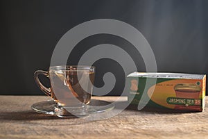 Tea cup with tea bag on old wood. Summer tea time