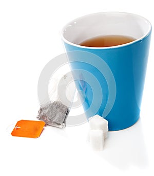 Tea cup, tea bag and sugar