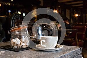 Tea cup, Teapot and sugar lumps in jar photo