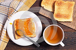 Tea cup and toast with jam