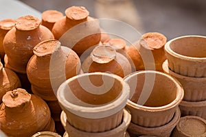 tea cups or pots made of clay kept together. Terracotta pots generally used in tea or coffee shops