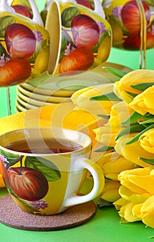 Tea cups and yellow tulips