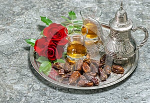 Tea, dates fruits and flowers. Islamic holidays decoration. Eid