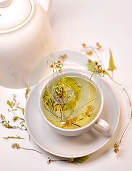 Tea from different herbs, clear medicinal tea, aromatic tea for winter and summer, kettle with tea, tea mug, herbs