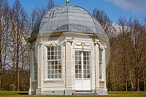 Tea dome or Theekoepel or Gloriette with its square windows and gray dome with bare trees in the background