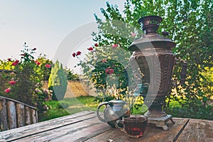 Tea drinking from a vintage samovar in garden