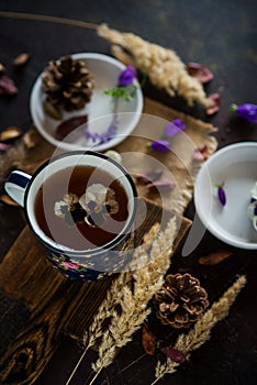 Tea with edible flowers, pansies. The concept of a cozy home autumn tea party