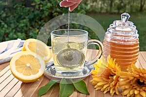 Tea filter ball falling into a glass of hot water