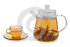 Tea with flowers in glass teapot and cup.