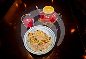 Tea from forest berries fruit with a slice of orange on a wooden