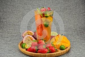 tea with fruits in a glass, mango, passion fruit, strawberry, lenon, watermelon, cut photo