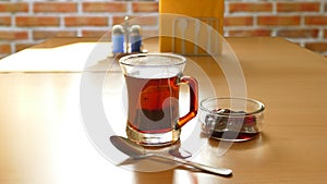 Tea in a glass on a brick background
