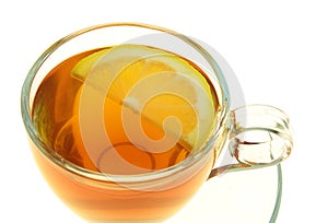 Tea in a glass cup with lemon slice isolated on white background