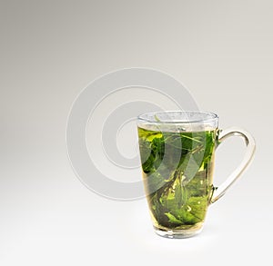 Tea glass with dried nettle tea