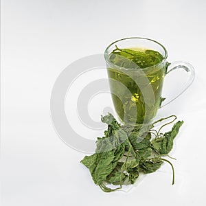 Tea glass with dried nettle tea