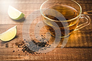 tea in glass with lemon segments on a wooden background/tea in glass with lemon segments on a wooden background. Top view