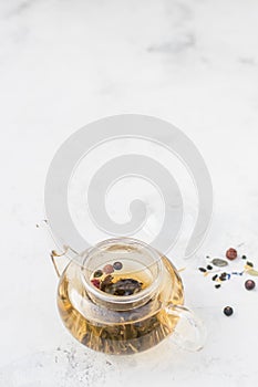 Tea in a glass teapot. Herbal Tea with Berries and Honey