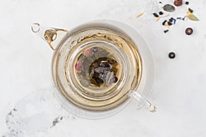 Tea in a glass teapot. Herbal Tea with Berries and Honey