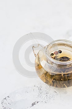 Tea in a glass teapot. Herbal Tea with Berries and Honey