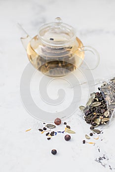 Tea in a glass teapot. Herbal Tea with Berries and Honey