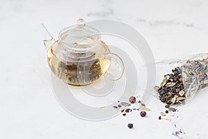 Tea in a glass teapot. Herbal Tea with Berries and Honey