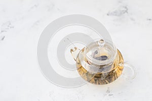 Tea in a glass teapot. Herbal Tea with Berries and Honey