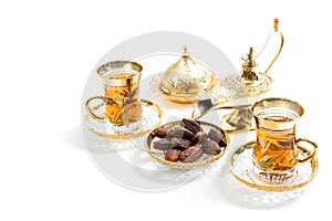 Tea glasses dates white background Oriental hospitality photo